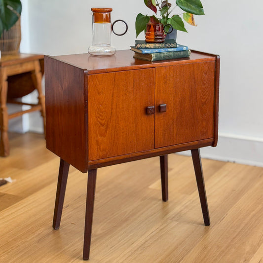 A vintage teak two door record cabinet