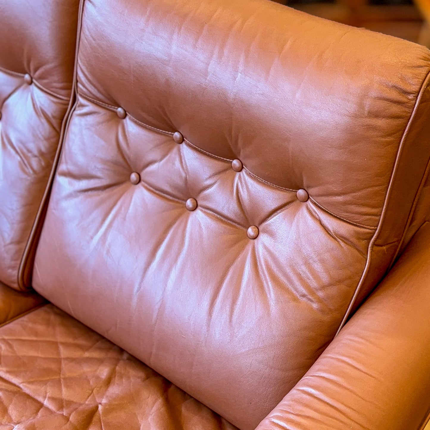 Leather upholstered three seater sofa