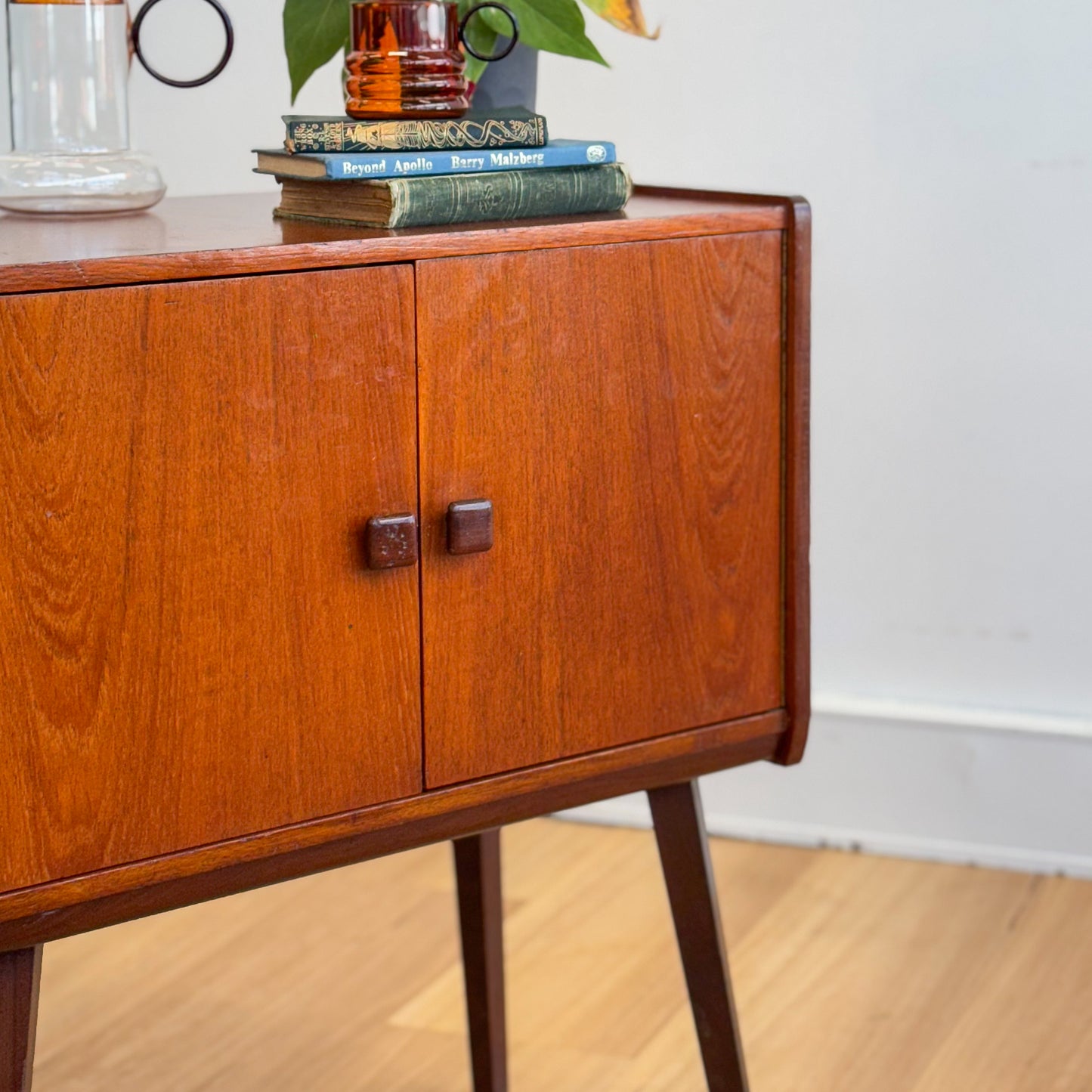 A vintage teak two door record cabinet