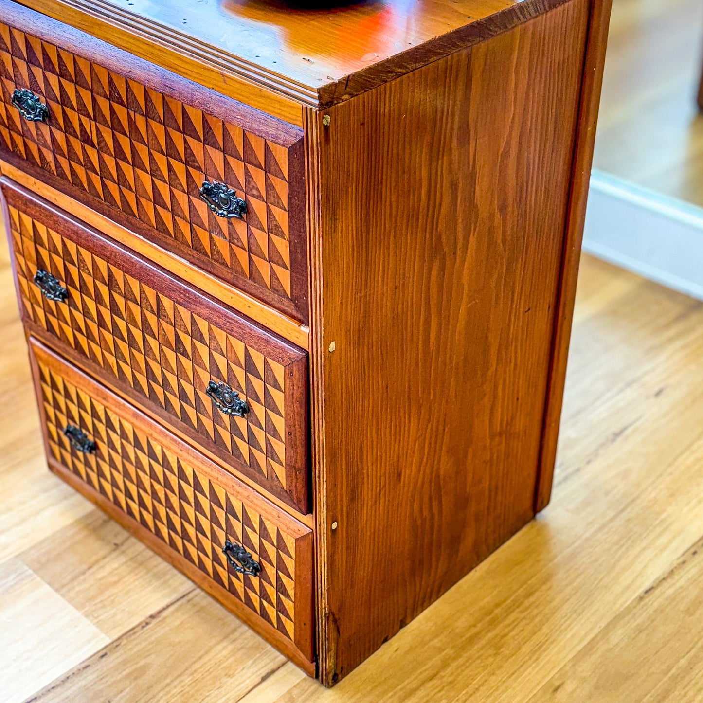 Marquetry chest of drawers featuring geometric design