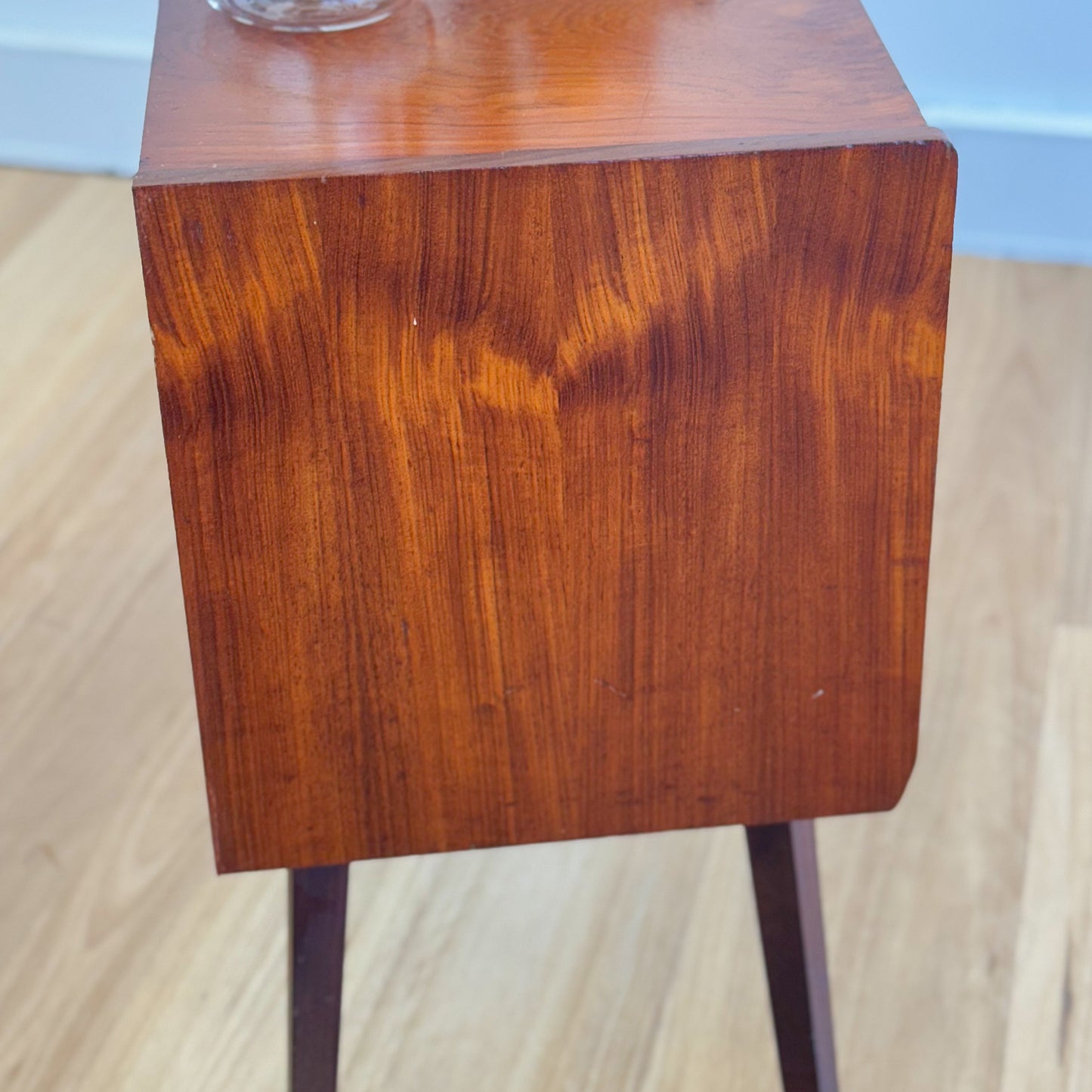 A vintage teak two door record cabinet