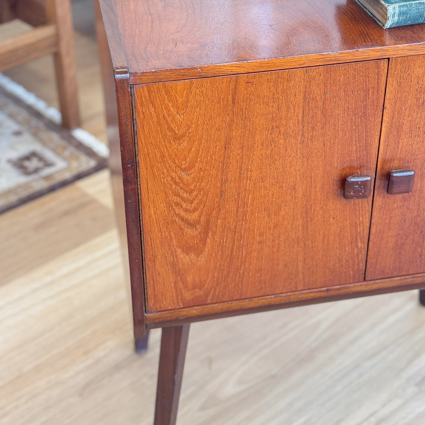 A vintage teak two door record cabinet