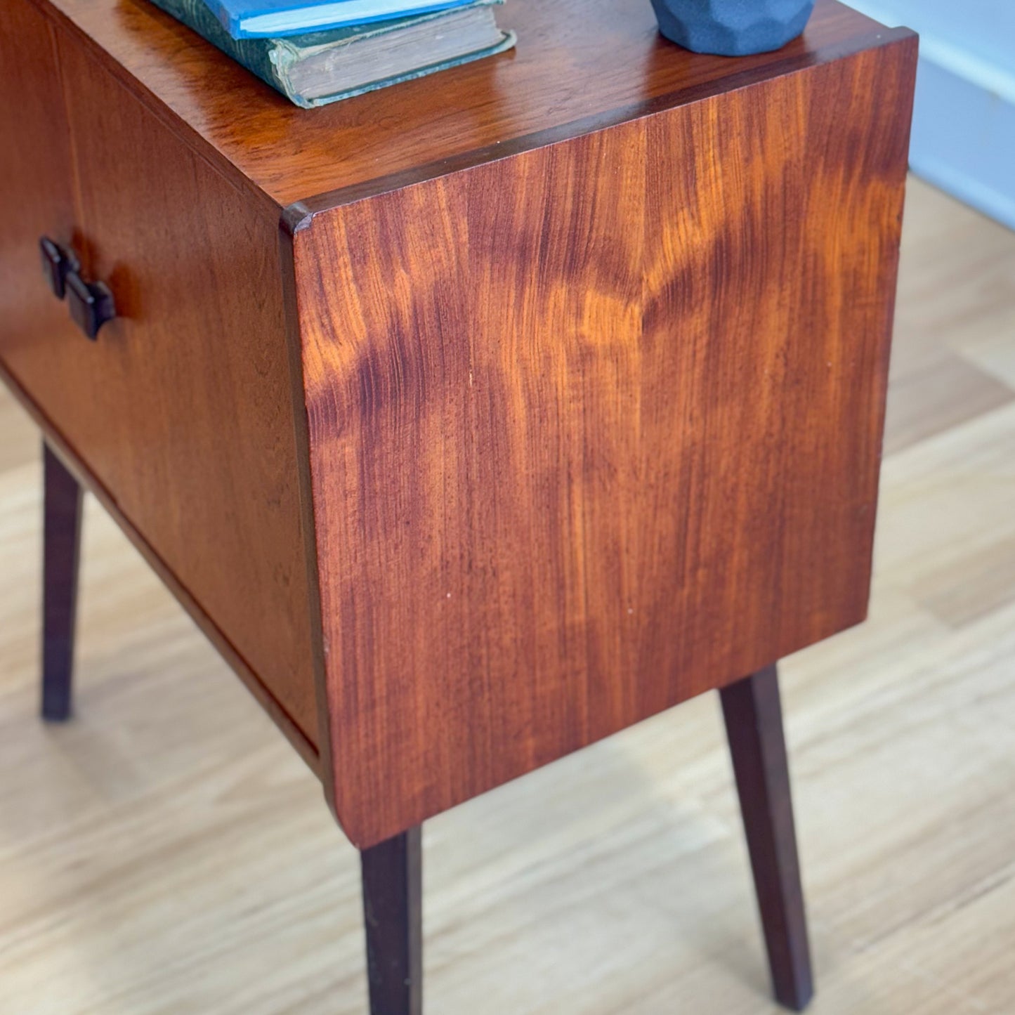 A vintage teak two door record cabinet