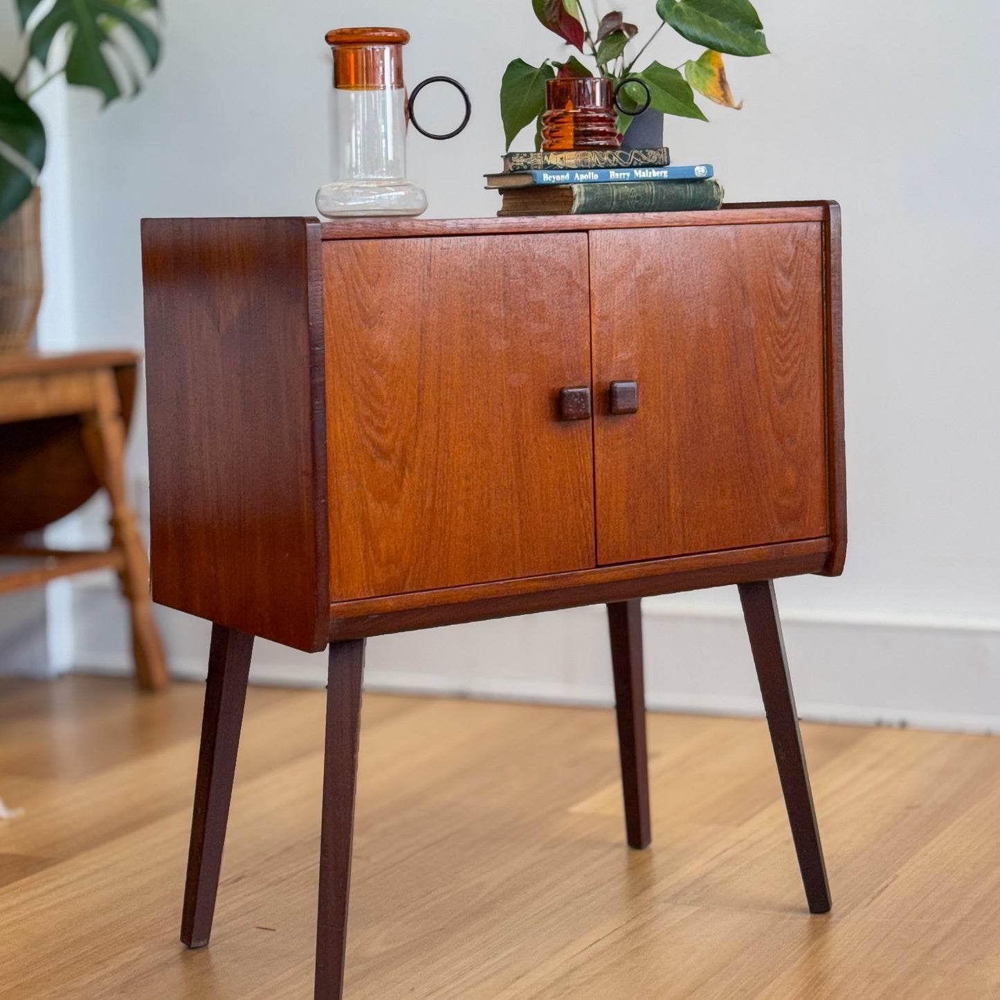 A vintage teak two door record cabinet